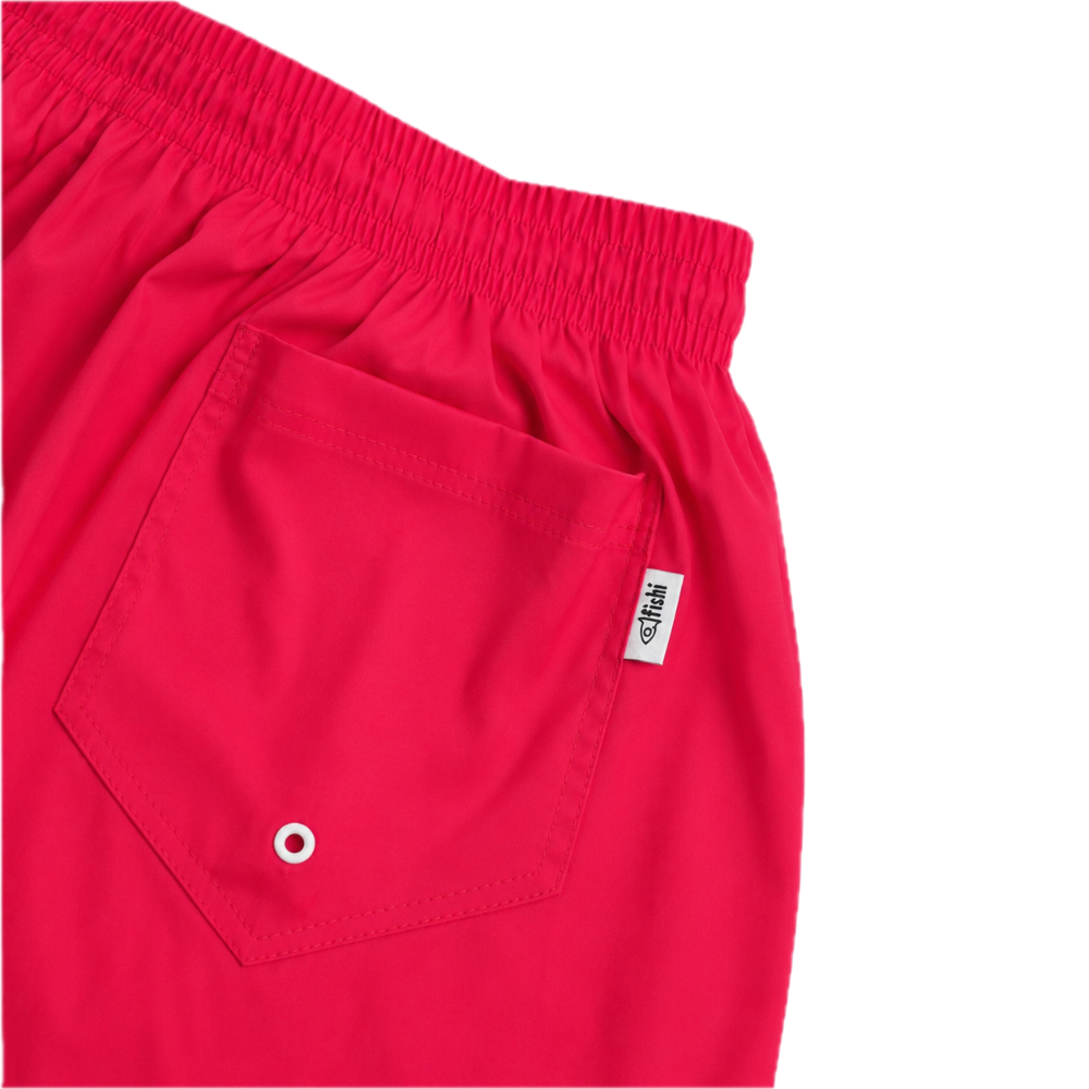Close-up of bright red swim trunks showing an elastic waistband, a side pocket with a metal grommet, and a small white brand tag reading 'Fishi'.